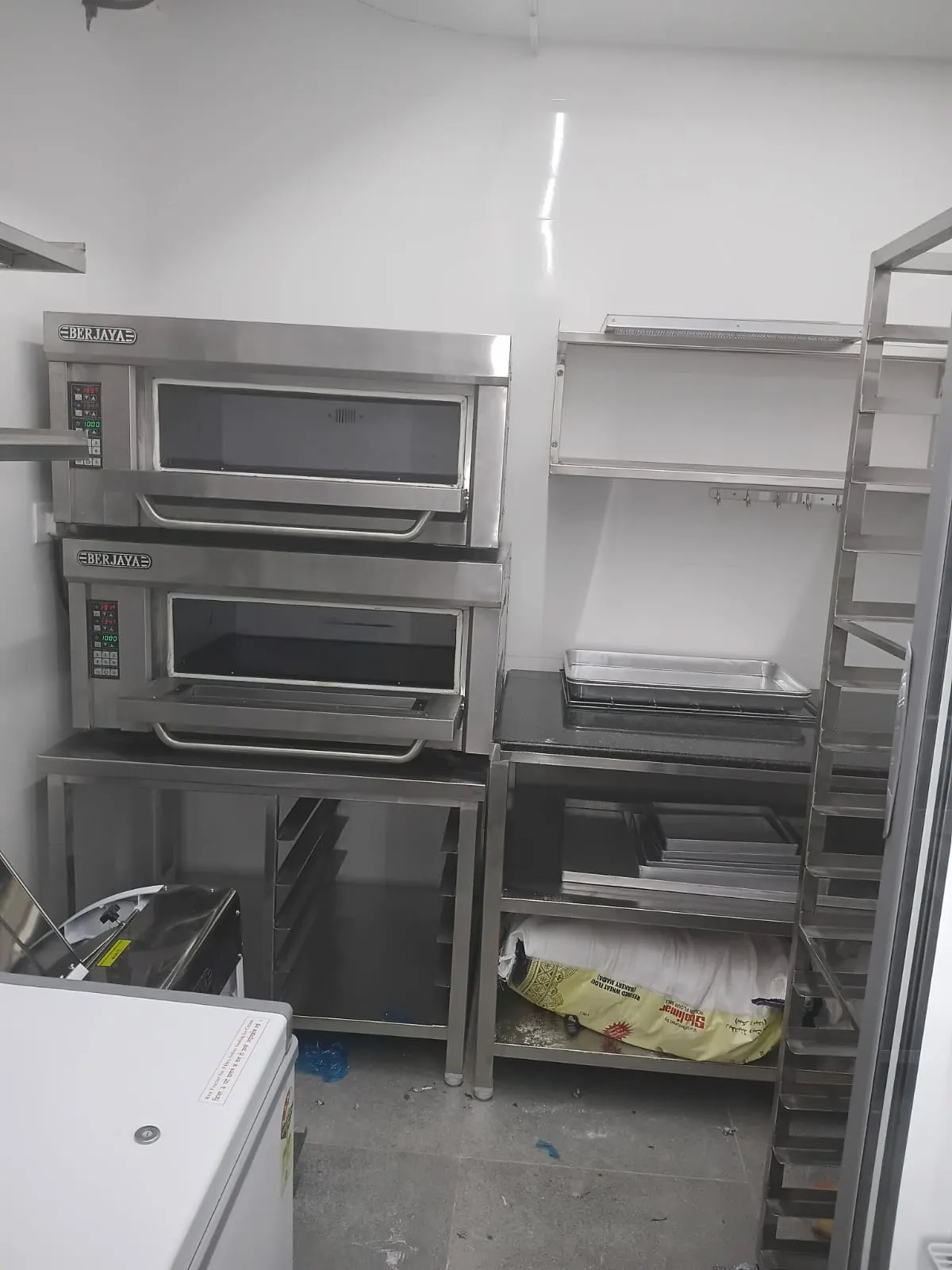 Stacked deck ovens with a bakery tray trolley