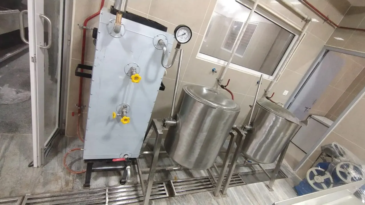 Steam boiler with pressure gauge connected to a stainless steel rice cooking vessel